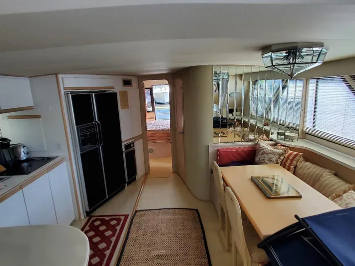  Yacht Photos Pics Interior of a 1991 Bluewater Yachts 60, featuring a cozy dining area and modern kitchen.