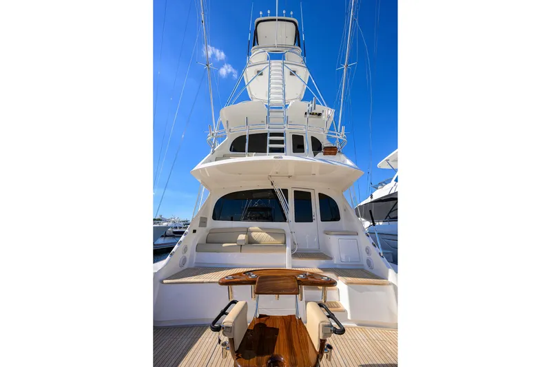 Torta Yacht Photos Pics 2017 Viking 72 Enclosed Bridge yacht with spacious deck and seating, under clear blue sky.