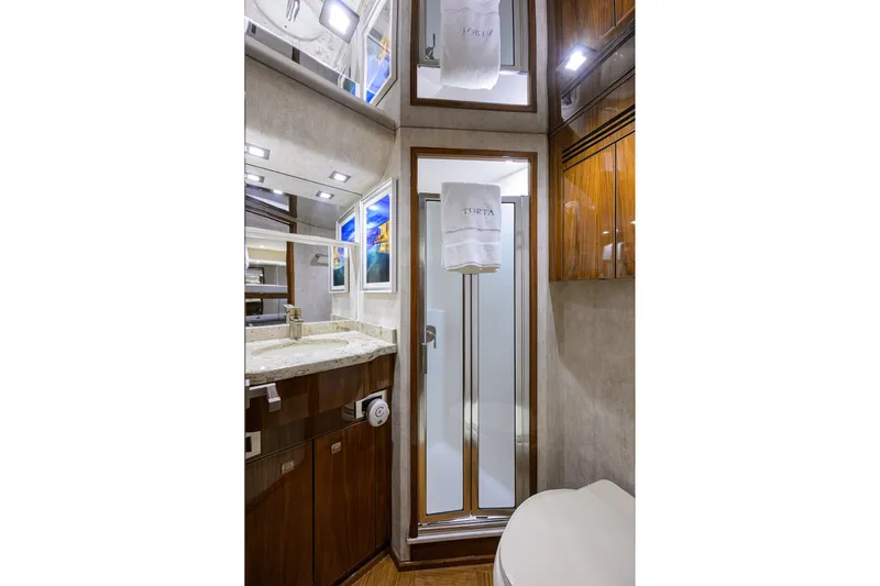 Torta Yacht Photos Pics Luxurious bathroom in 2017 Viking 72 Enclosed Bridge yacht with modern fixtures and elegant design.