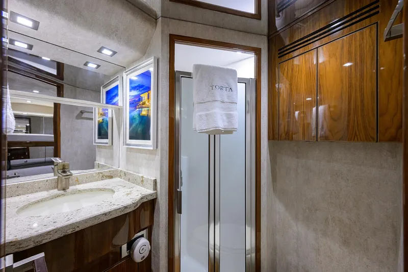 Torta Yacht Photos Pics Luxurious bathroom in 2017 Viking 72 Enclosed Bridge yacht with elegant wood cabinetry.