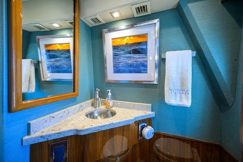 Torta Yacht Photos Pics Luxurious bathroom in 2017 Viking 72 Enclosed Bridge yacht with ocean-themed decor.
