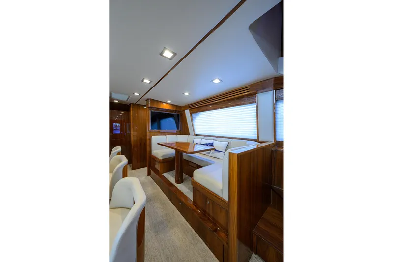 Torta Yacht Photos Pics Luxurious interior of 2017 Viking 72 Enclosed Bridge yacht with elegant seating and wood finishes.