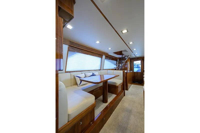 Torta Yacht Photos Pics Luxurious interior of 2017 Viking 72 Enclosed Bridge yacht with elegant seating and wooden finishes.