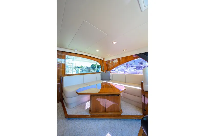 Torta Yacht Photos Pics Luxurious interior of 2017 Viking 72 Enclosed Bridge yacht with elegant seating and wooden accents.