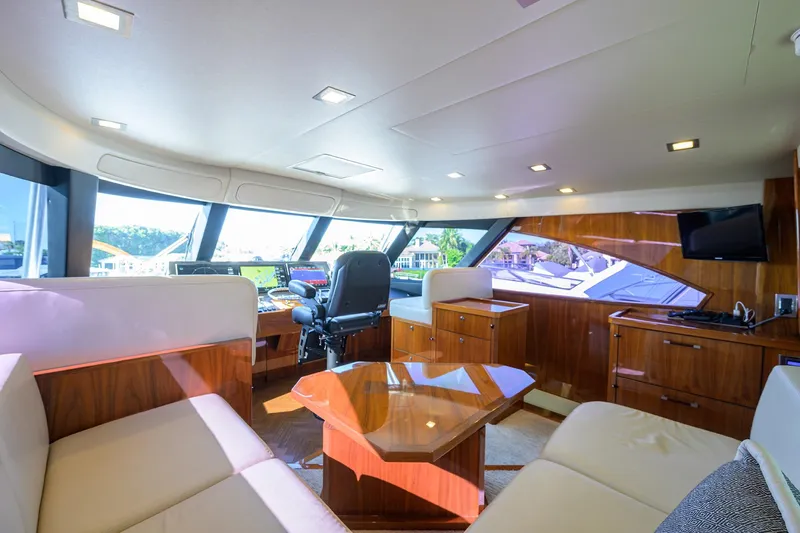 Torta Yacht Photos Pics Luxurious interior of 2017 Viking 72 Enclosed Bridge yacht with modern furnishings and panoramic windows.