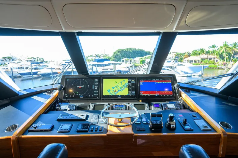 Torta Yacht Photos Pics Cockpit view of 2017 Viking 72 Enclosed Bridge yacht with advanced navigation systems.
