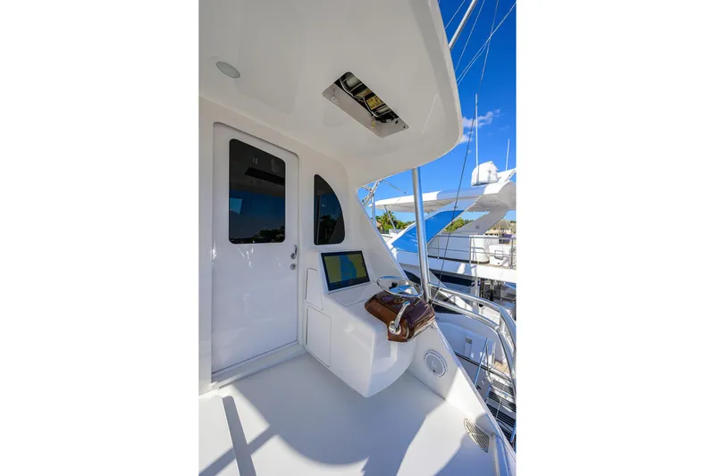 Torta Yacht Photos Pics 2017 Viking 72 Enclosed Bridge yacht helm with navigation equipment and clear blue sky.