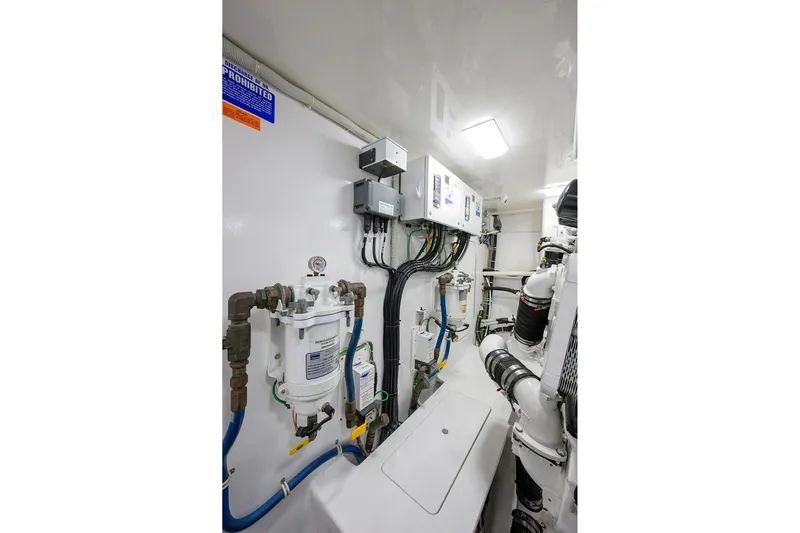 Torta Yacht Photos Pics Engine room of 2017 Viking 72 Enclosed Bridge yacht, featuring complex wiring and equipment.