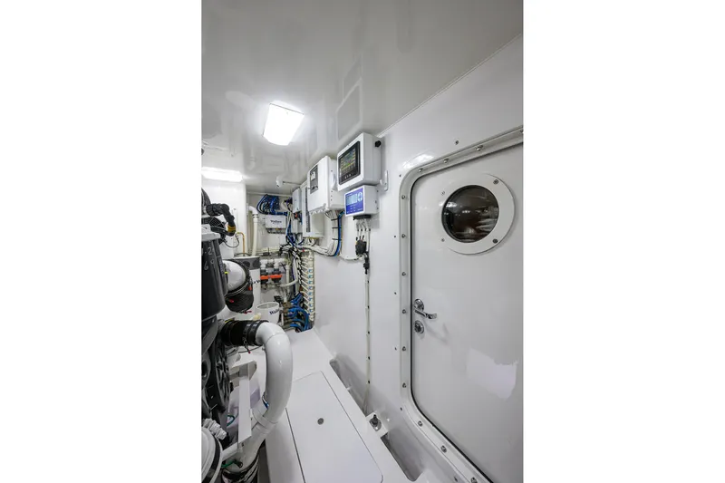 Torta Yacht Photos Pics Engine room of 2017 Viking 72 Enclosed Bridge yacht, featuring control panels and equipment.