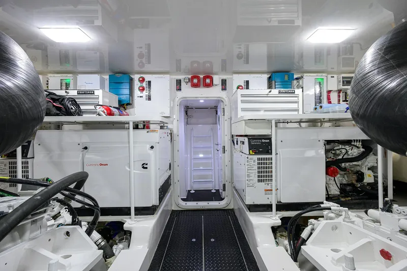 Torta Yacht Photos Pics Engine room of 2017 Viking 72 Enclosed Bridge yacht, featuring Cummins Onan generators.