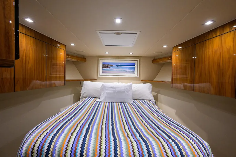 Torta Yacht Photos Pics Luxurious cabin interior of 2017 Viking 72 Enclosed Bridge yacht with colorful bedding.