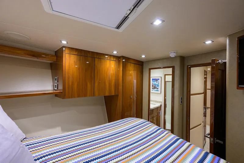 Torta Yacht Photos Pics Luxurious bedroom interior of 2017 Viking 72 Enclosed Bridge yacht with wood cabinetry.