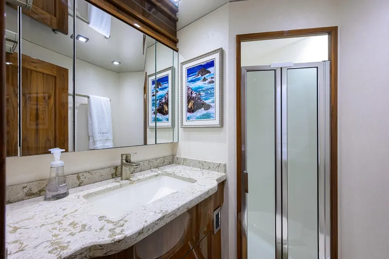 Torta Yacht Photos Pics Luxurious bathroom in 2017 Viking 72 Enclosed Bridge yacht with modern fixtures and elegant decor.