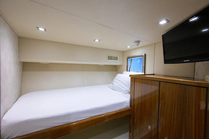 Torta Yacht Photos Pics Luxurious cabin interior of 2017 Viking 72 Enclosed Bridge yacht with bed and TV.