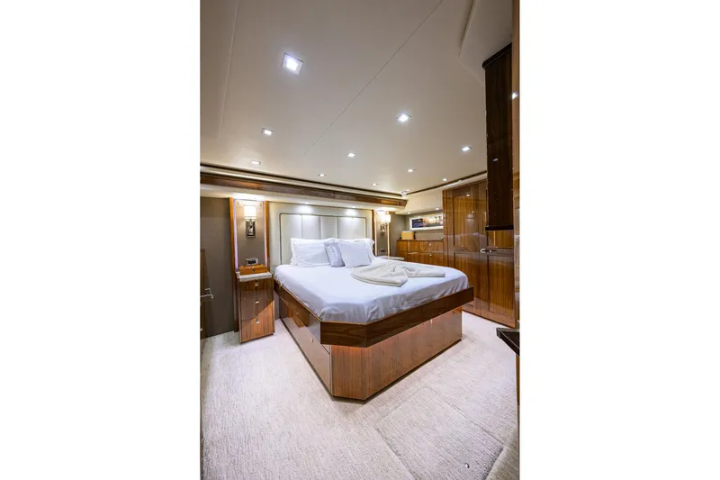 Torta Yacht Photos Pics Luxurious bedroom interior of 2017 Viking 72 Enclosed Bridge yacht with elegant wood finishes.