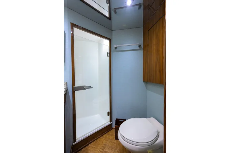 Torta Yacht Photos Pics Bathroom interior of 2017 Viking 72 Enclosed Bridge yacht, featuring shower and toilet.
