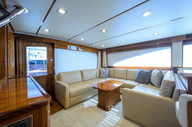 Torta Yacht Photos Pics Luxurious interior of 2017 Viking 72 Enclosed Bridge yacht with plush seating and elegant wood finishes.