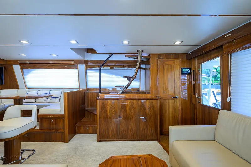 Torta Yacht Photos Pics Luxurious interior of 2017 Viking 72 Enclosed Bridge yacht with elegant wood finishes.