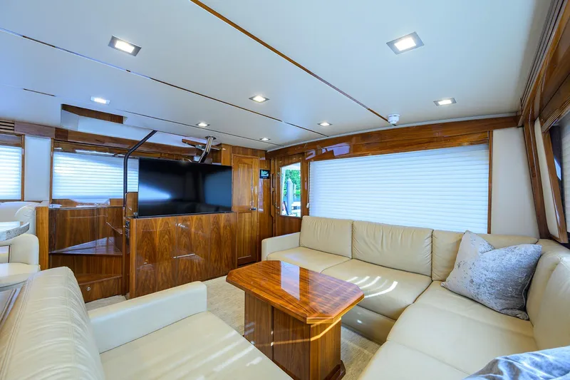 Torta Yacht Photos Pics Luxurious interior of 2017 Viking 72 Enclosed Bridge yacht with plush seating and modern amenities.