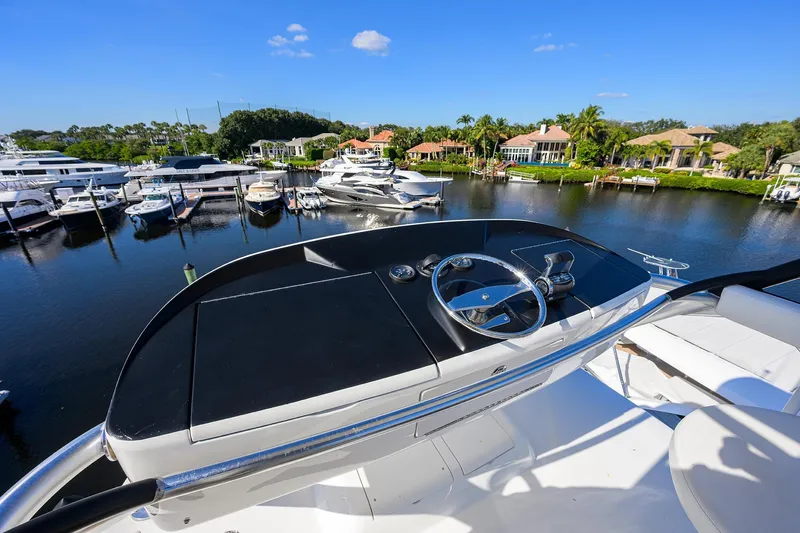 Torta Yacht Photos Pics 2017 Viking 72 Enclosed Bridge yacht helm overlooking marina and waterfront homes.