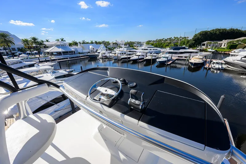 Torta Yacht Photos Pics 2017 Viking 72 Enclosed Bridge yacht helm overlooking marina with docked boats.