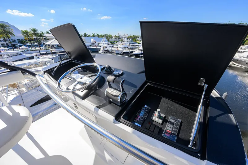 Torta Yacht Photos Pics Control panel of 2017 Viking 72 Enclosed Bridge yacht, featuring steering wheel and navigation controls.