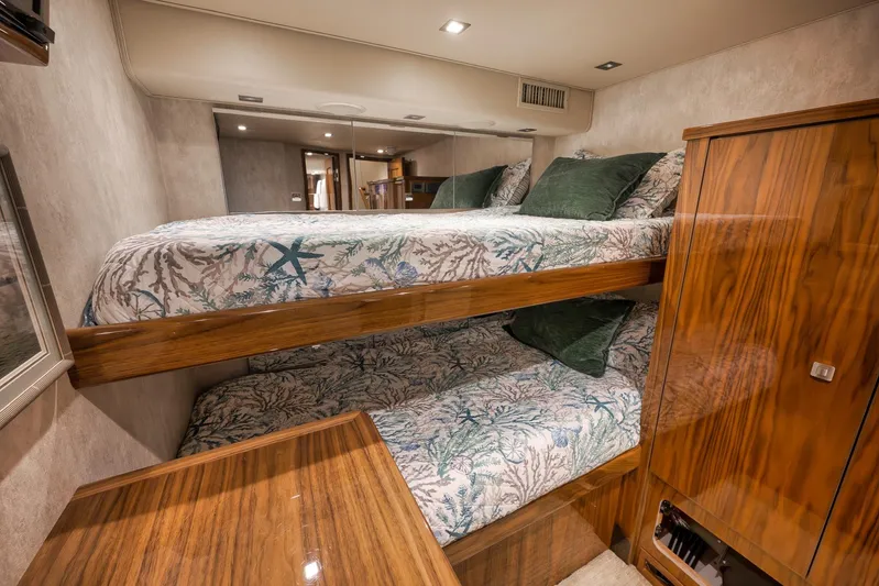 Torta Yacht Photos Pics Luxurious 2017 Viking 72 Enclosed Bridge yacht cabin with bunk beds and elegant wood finish.