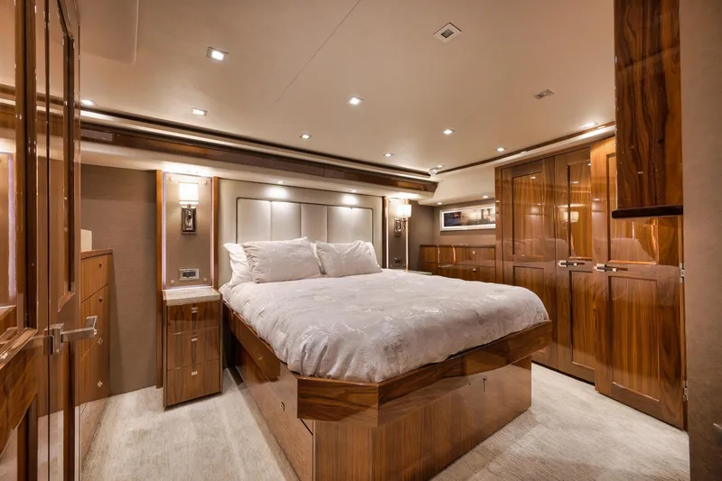 Torta Yacht Photos Pics Luxurious bedroom interior of 2017 Viking 72 Enclosed Bridge yacht with elegant wood finishes.