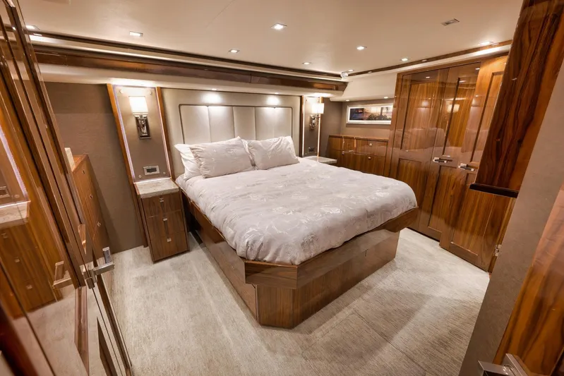 Torta Yacht Photos Pics Luxurious bedroom interior of 2017 Viking 72 Enclosed Bridge yacht with elegant wood finishes.