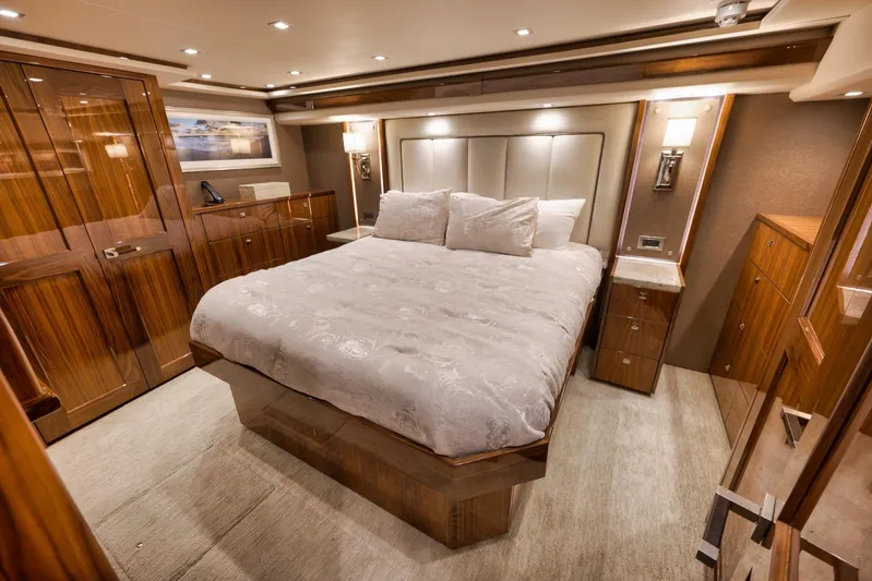 Torta Yacht Photos Pics Luxurious bedroom interior of 2017 Viking 72 Enclosed Bridge yacht with elegant wood finishes.