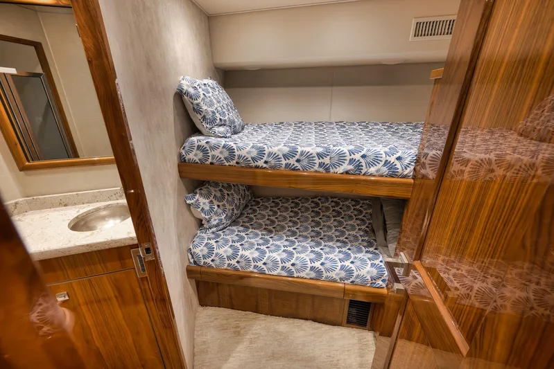 Torta Yacht Photos Pics Bunk beds in 2017 Viking 72 Enclosed Bridge yacht cabin with patterned bedding.