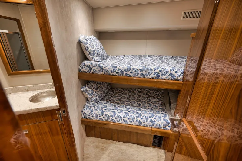 Torta Yacht Photos Pics Bunk beds in 2017 Viking 72 Enclosed Bridge yacht cabin with wooden finishes.