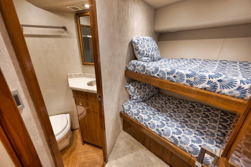 Torta Yacht Photos Pics 2017 Viking 72 Enclosed Bridge interior with bunk beds and compact bathroom.
