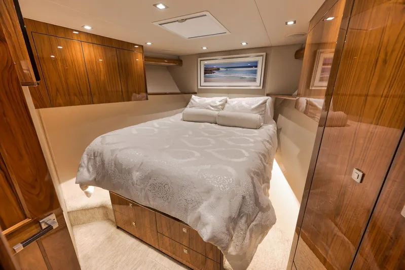 Torta Yacht Photos Pics Luxurious bedroom interior of 2017 Viking 72 Enclosed Bridge yacht with elegant wood finishes.