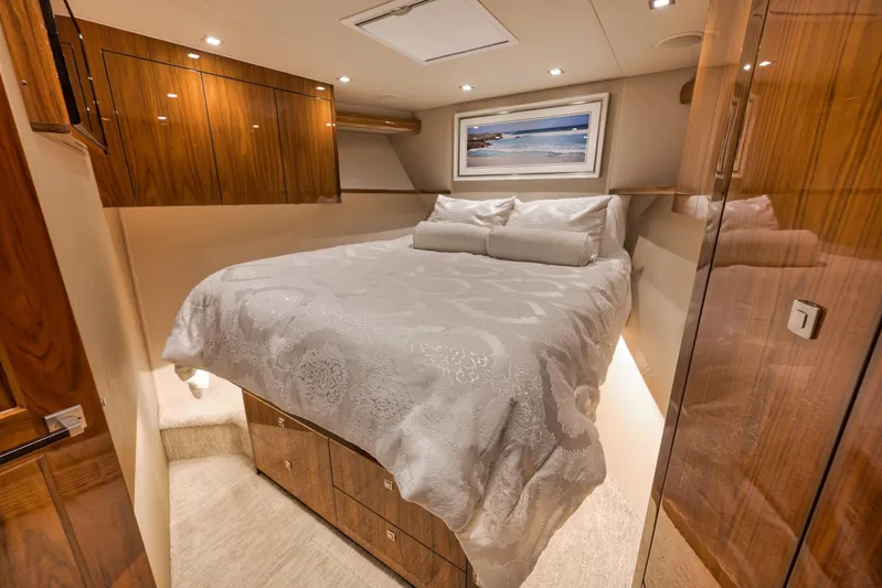 Torta Yacht Photos Pics Luxurious bedroom interior of 2017 Viking 72 Enclosed Bridge yacht with elegant wood finishes.