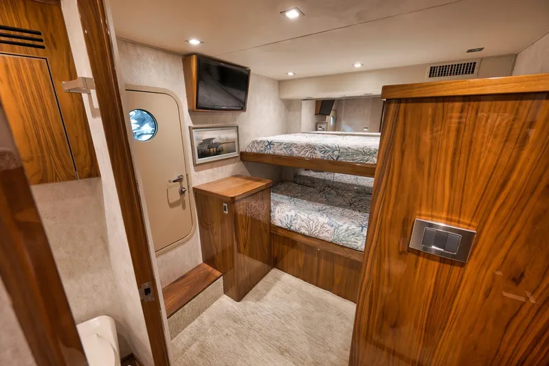 Torta Yacht Photos Pics Luxurious 2017 Viking 72 Enclosed Bridge yacht cabin with wooden interior and bunk beds.