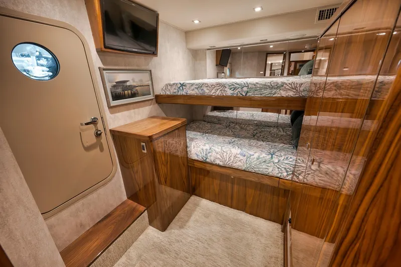 Torta Yacht Photos Pics Luxurious 2017 Viking 72 Enclosed Bridge yacht interior with bunk beds and elegant wood finishes.