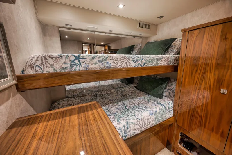 Torta Yacht Photos Pics Luxurious 2017 Viking 72 Enclosed Bridge yacht cabin with bunk beds and elegant wood finish.