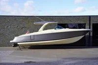 2024 Chris-Craft Launch 35GT boat displayed outdoors against a stone wall background.