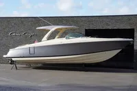 2024 Chris-Craft Launch 35GT boat displayed outdoors against a stone wall.