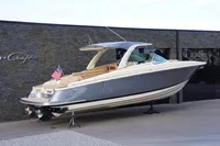 2024 Chris-Craft Launch 35GT boat displayed outdoors, featuring sleek design and American flag.