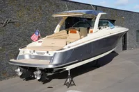 2024 Chris-Craft Launch 35GT boat displayed outdoors, featuring sleek design and American flag.