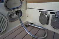 2024 Chris-Craft Launch 35GT boat interior with utility connections and speaker.