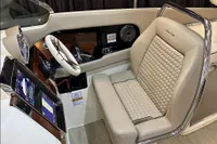 2024 Chris-Craft Launch 35GT cockpit with luxurious beige seating and modern dashboard.