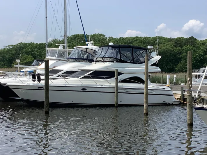Knot On Call II Yacht Photos Pics 2000 Maxum 4600 SCB yacht docked at marina, surrounded by water and trees.
