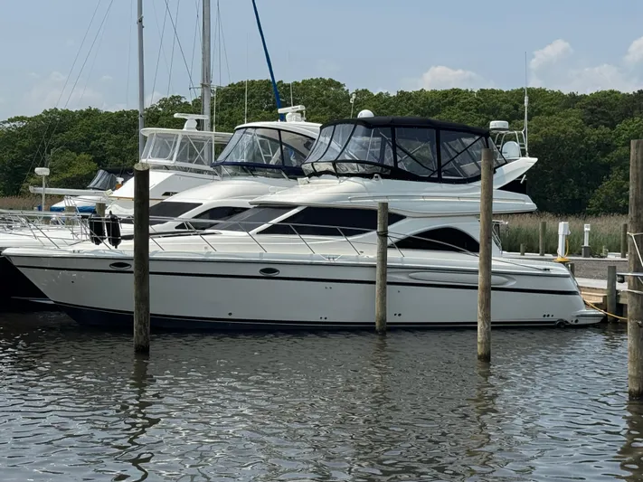 Knot On Call II Yacht Photos Pics 2000 Maxum 4600 SCB yacht docked at a marina, surrounded by other boats.