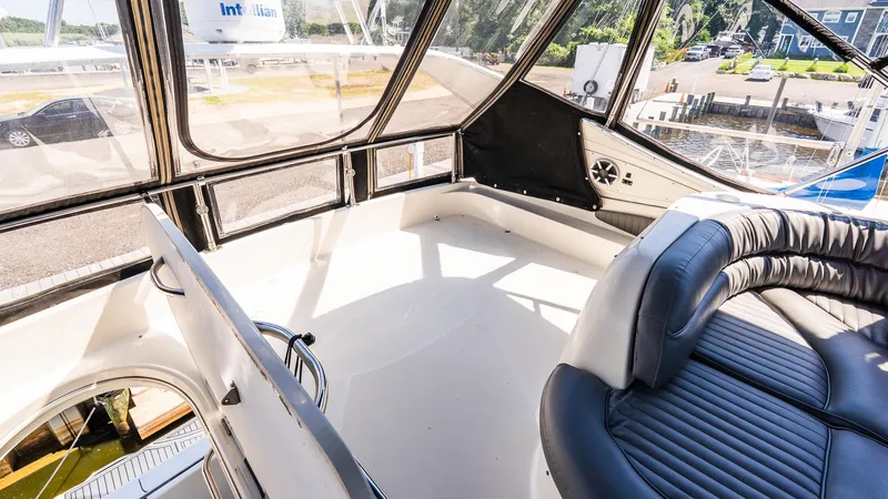 Knot On Call II Yacht Photos Pics Interior view of 2000 Maxum 4600 SCB yacht with seating and windows.