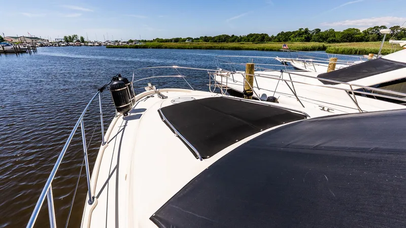 Knot On Call II Yacht Photos Pics 2000 Maxum 4600 SCB yacht docked in a serene marina setting.