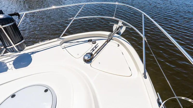 Knot On Call II Yacht Photos Pics Bow of 2000 Maxum 4600 SCB yacht with stainless steel railings on water.