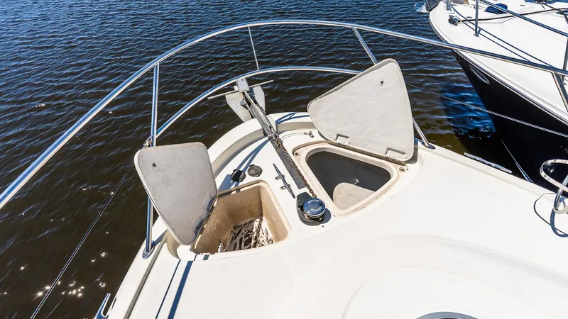 Knot On Call II Yacht Photos Pics Bow of 2000 Maxum 4600 SCB yacht with open anchor hatches on calm water.